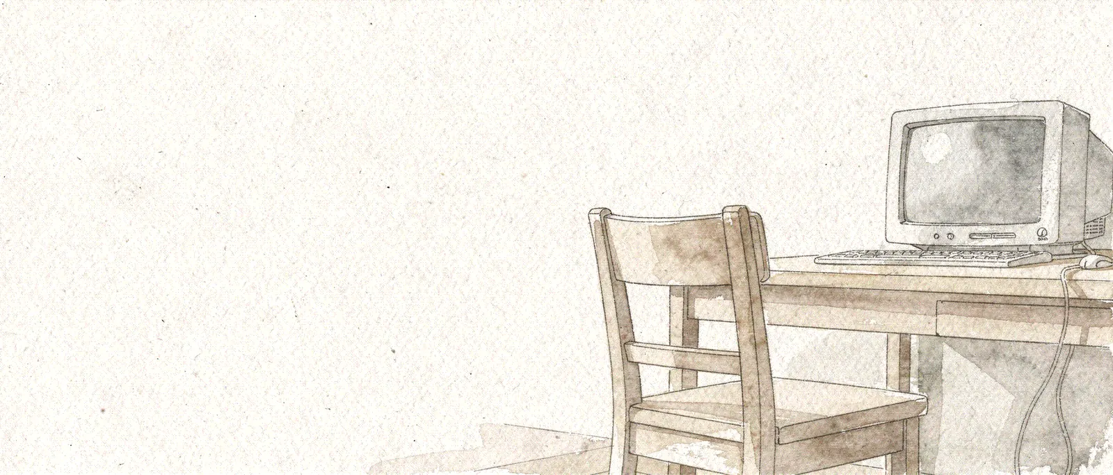 An open chair at a desk with a classic computer